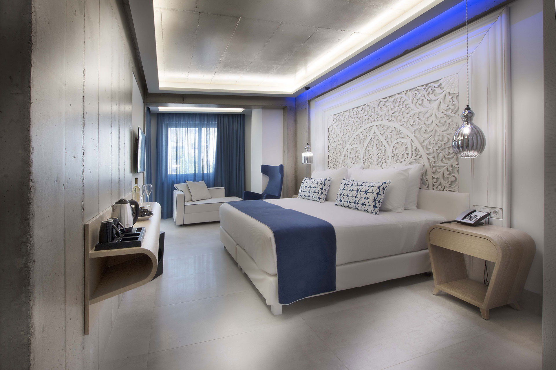 Cretan Blue Beach Hotel hotel room with double bed, white couch and coffee machine