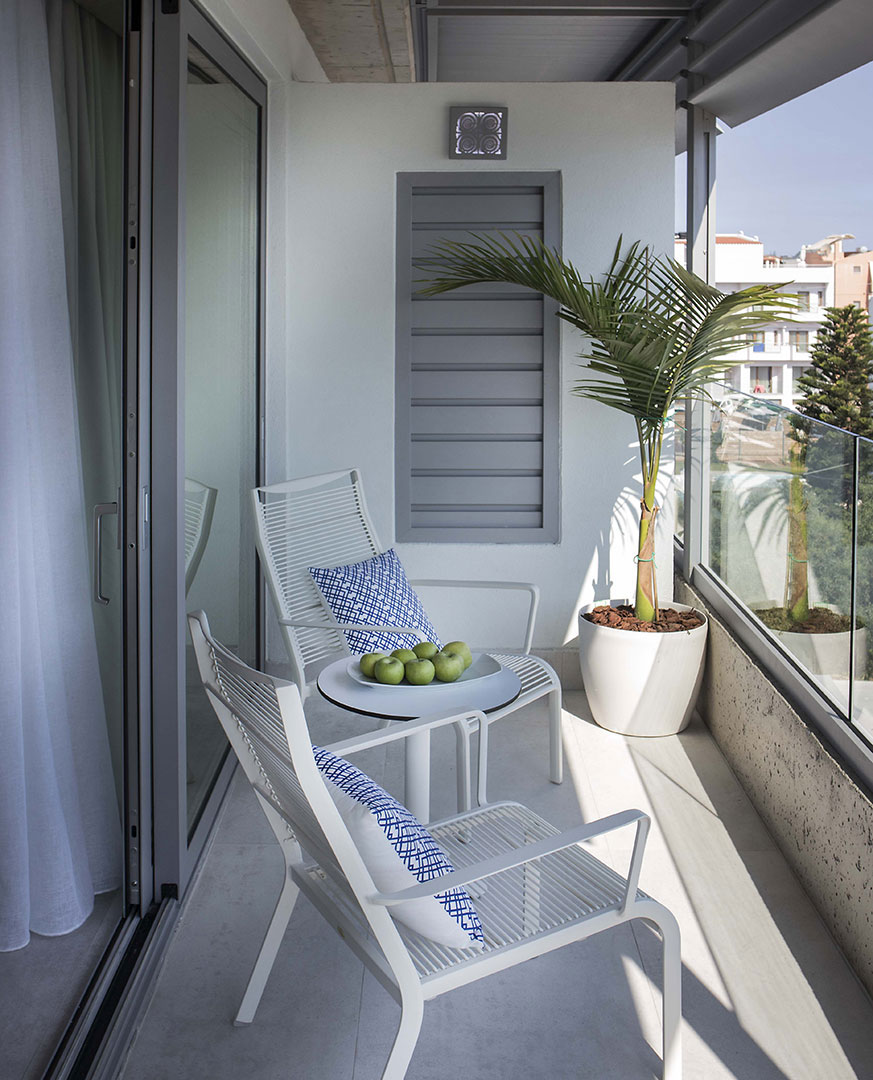 Cretan Blue Beach Hotel room balcony with table and chairs